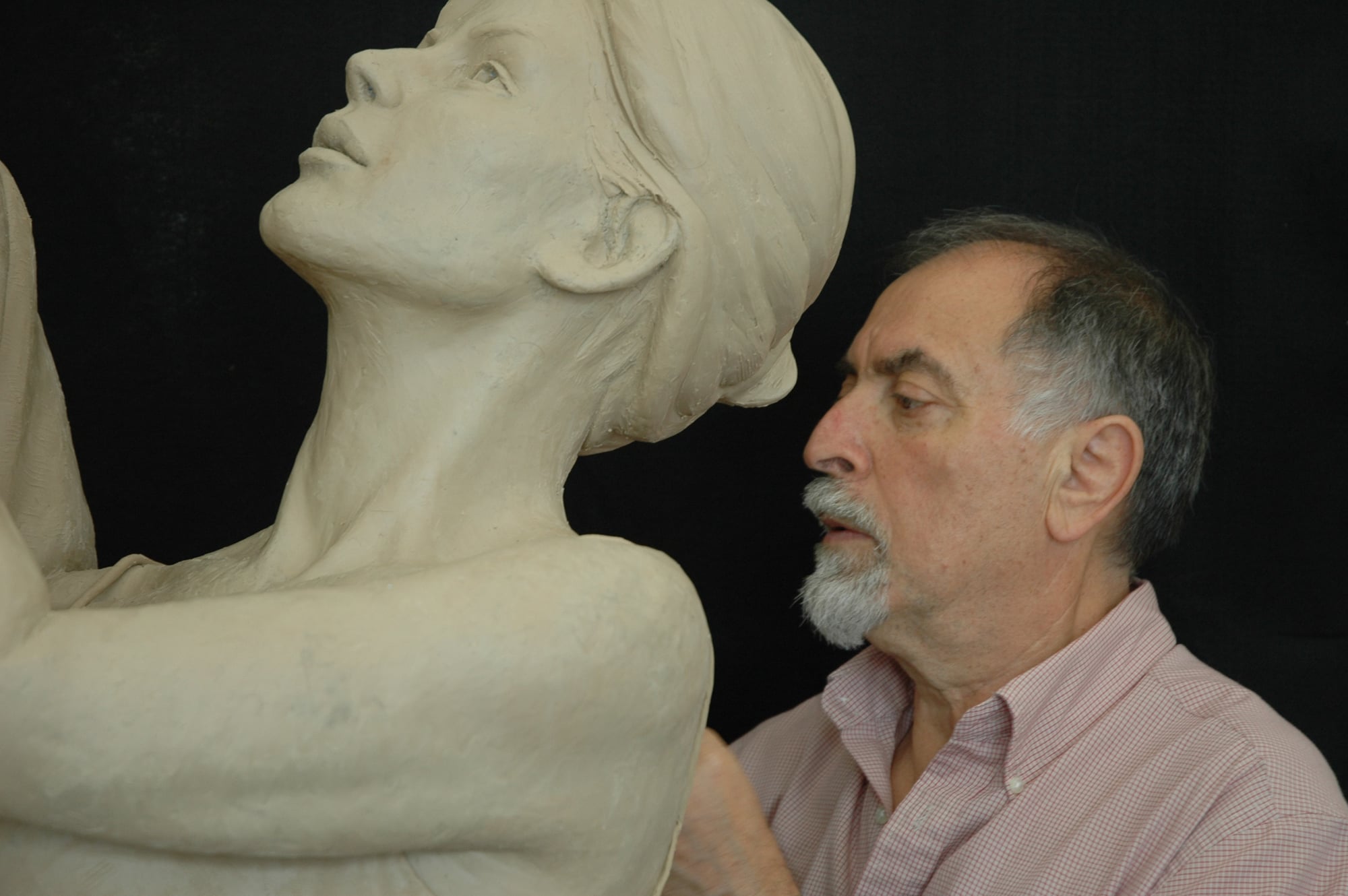 Alex focuses intently as he attends to details on the sculpture.
